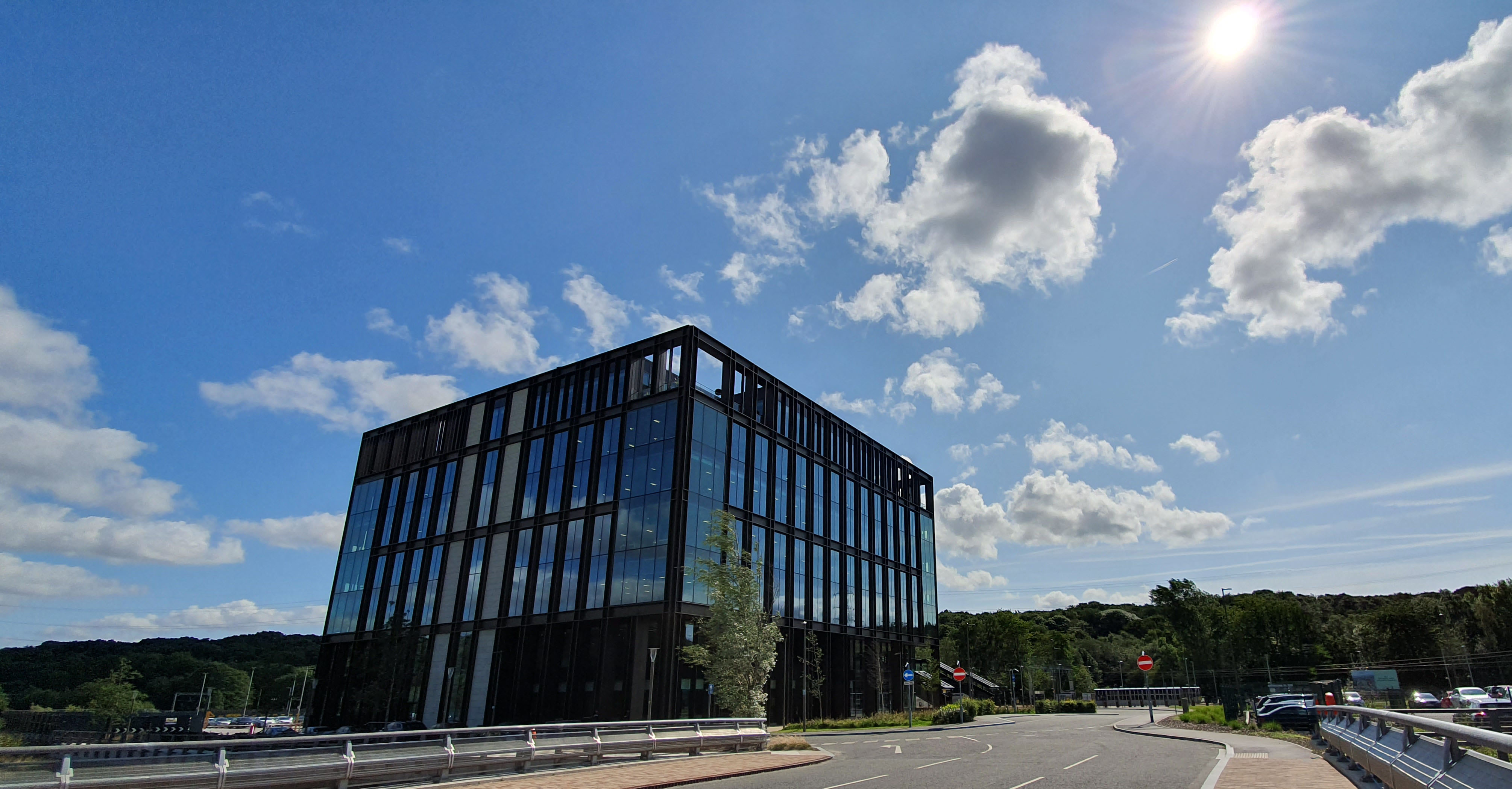 Picture of a modern office building against a blue sky
