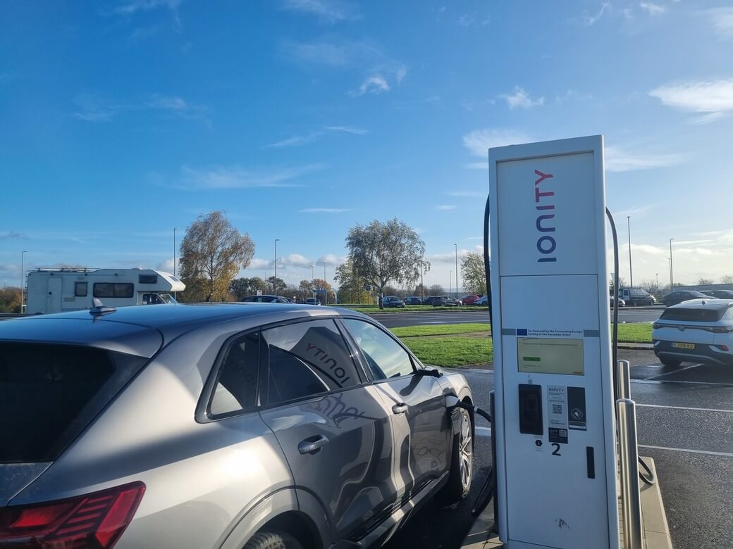 A grey Audi E-tron charges