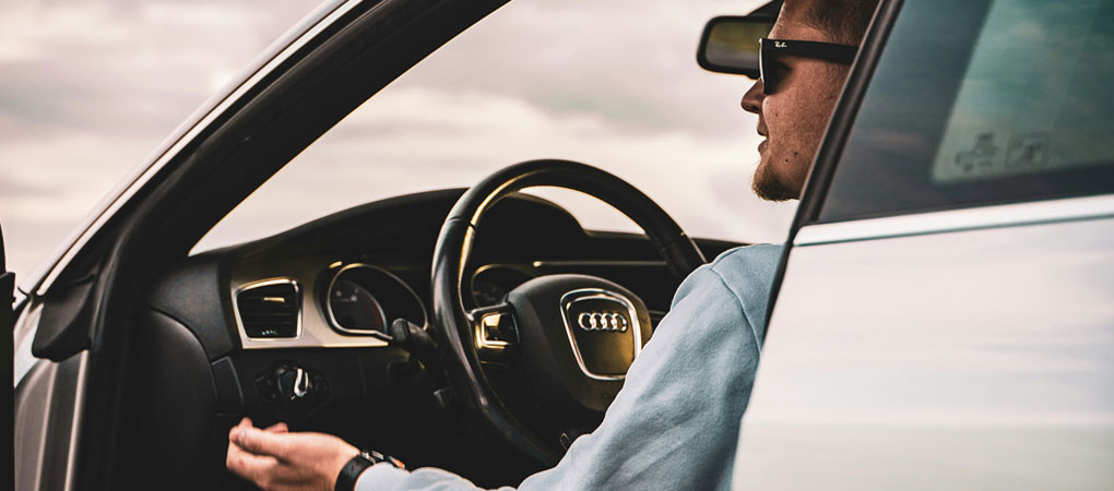 Young man driving an Audi